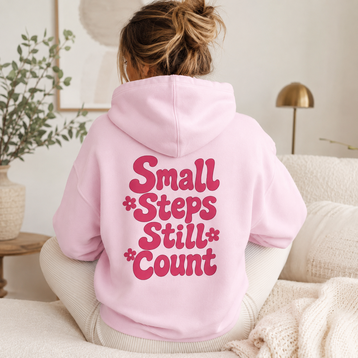 Small Steps Still Count hoodie in Light Pink with a colourful floral back print