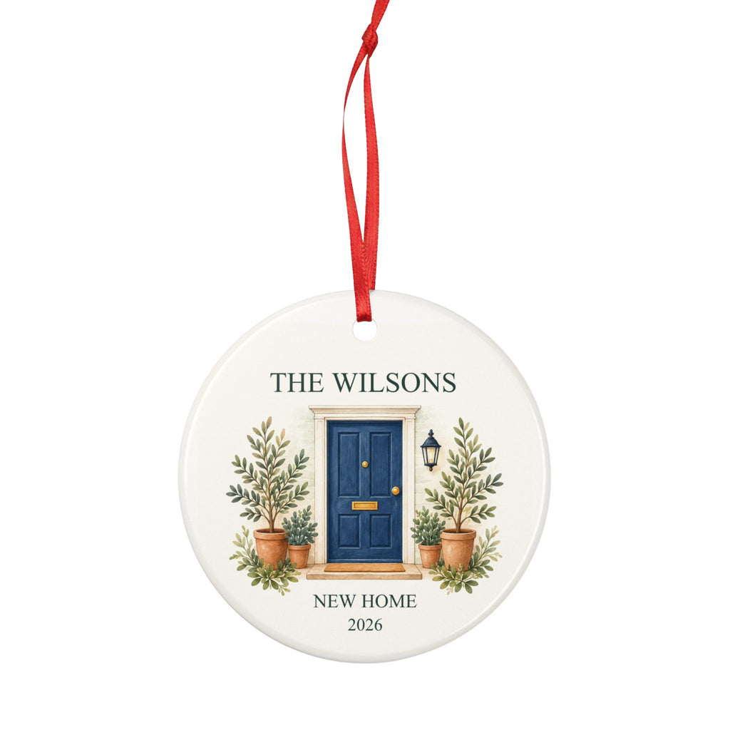 Round ceramic hanging ornament showing navy front door with plants, the sample family name The Wilsons and New Home wording.
