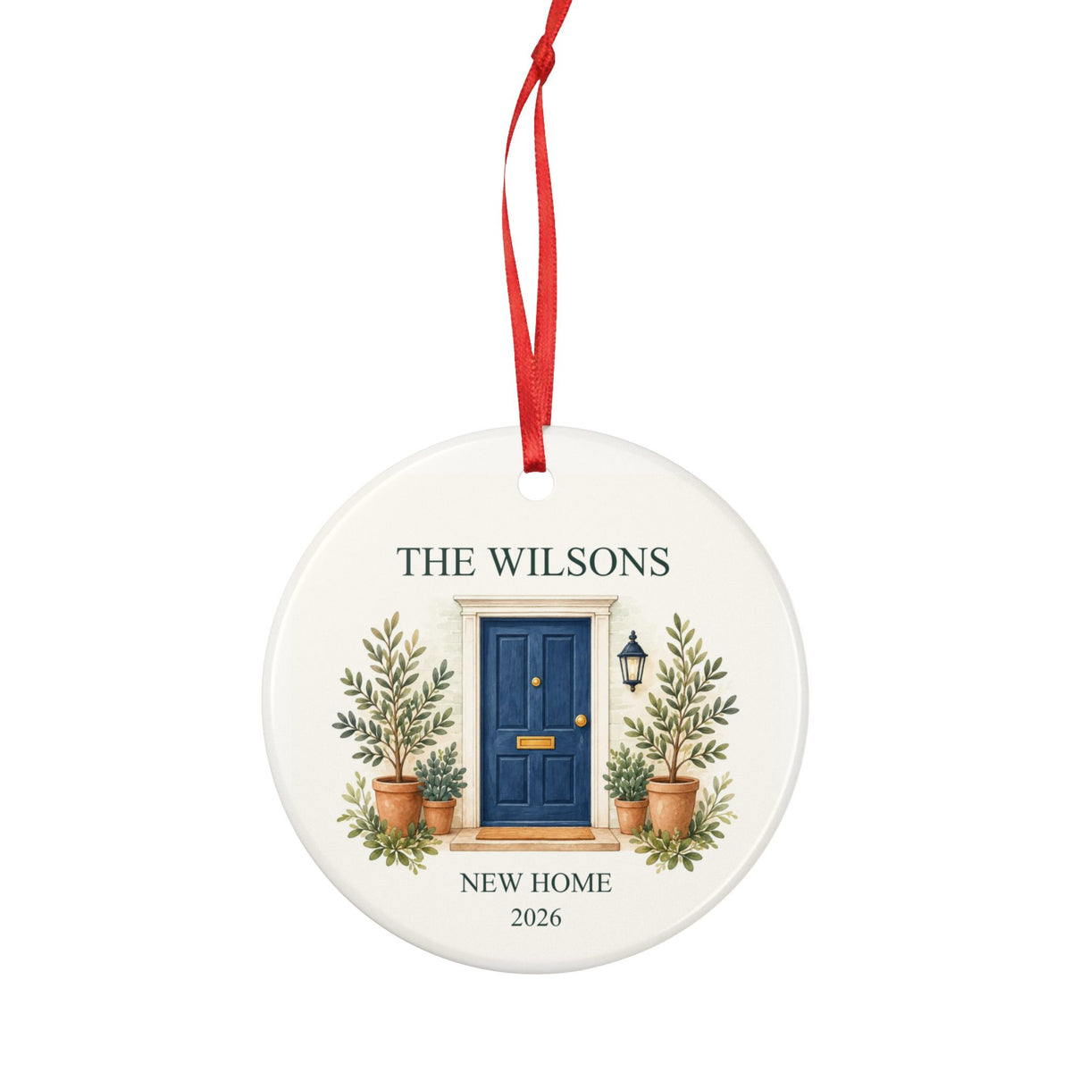 Round ceramic hanging ornament showing navy front door with plants, the sample family name The Wilsons and New Home wording.