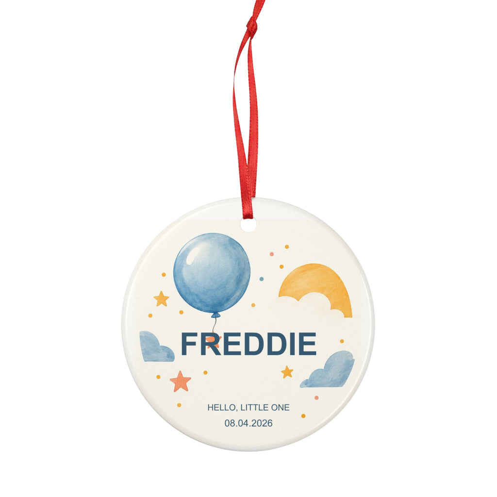 Round ceramic hanging ornament showing blue balloon, yellow sun and stars with the sample name Freddie and sample birth date.