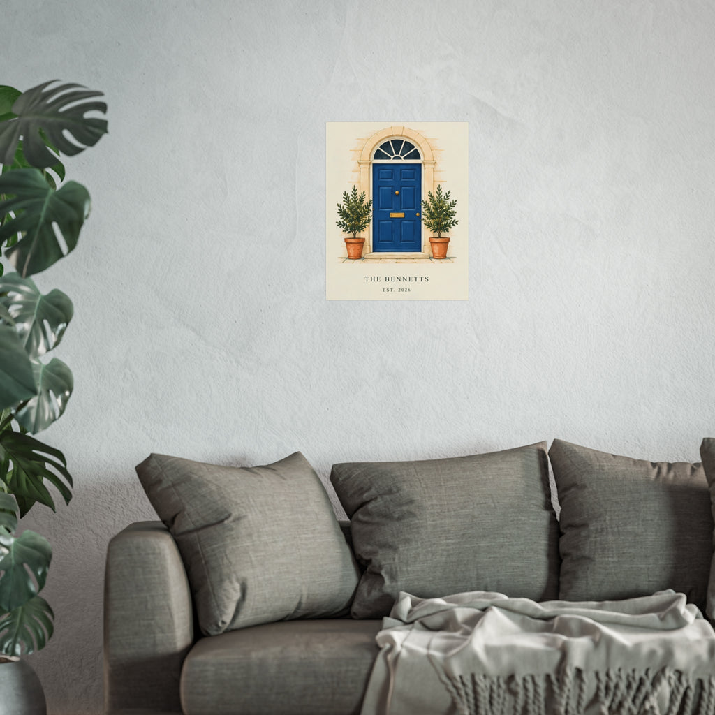 Our Little Door personalised blue-door art print with example household wording, shown on a pale wall above a grey sofa for scale