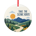 Round ceramic hanging ornament showing winding path through green hills and blue mountains with Take the Scenic Route lettering.