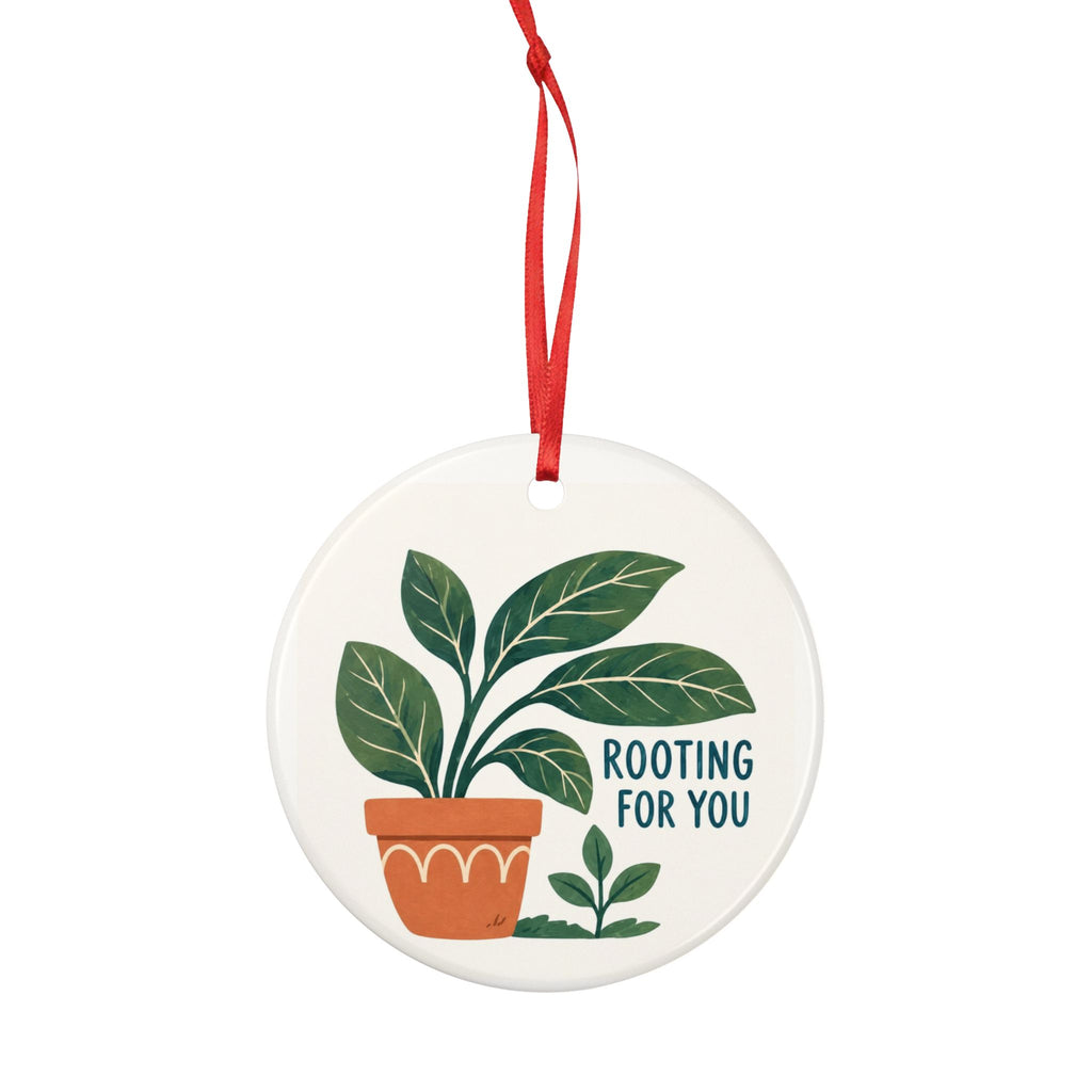 Round ceramic hanging ornament showing green leafy plant in a terracotta pot and Rooting for You lettering.