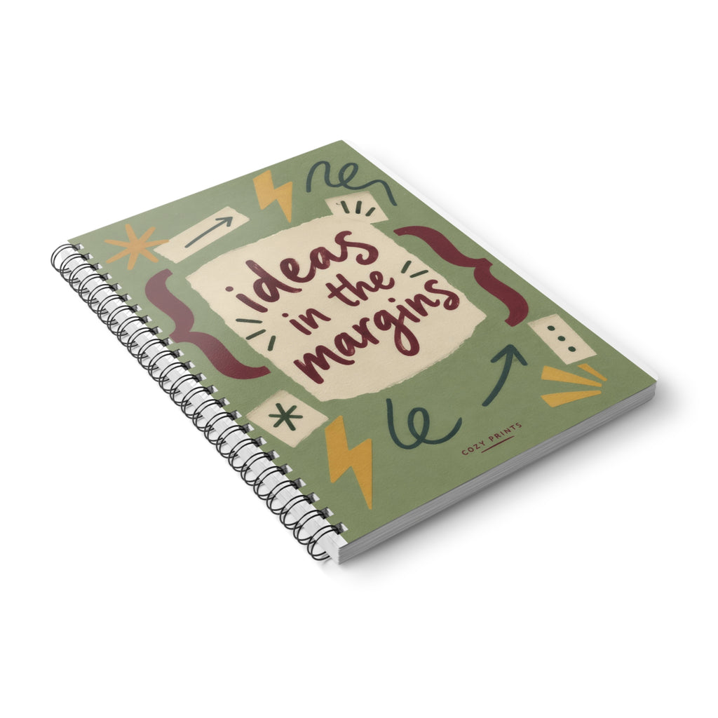 Ideas in the Margins A5 notebook by Cozy Prints UK, showing the illustrated front cover and black wire binding.