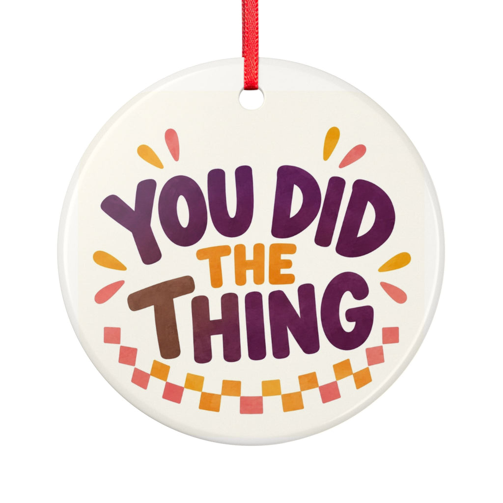Round ceramic hanging ornament showing bold You Did the Thing lettering with confetti and a checker garland.