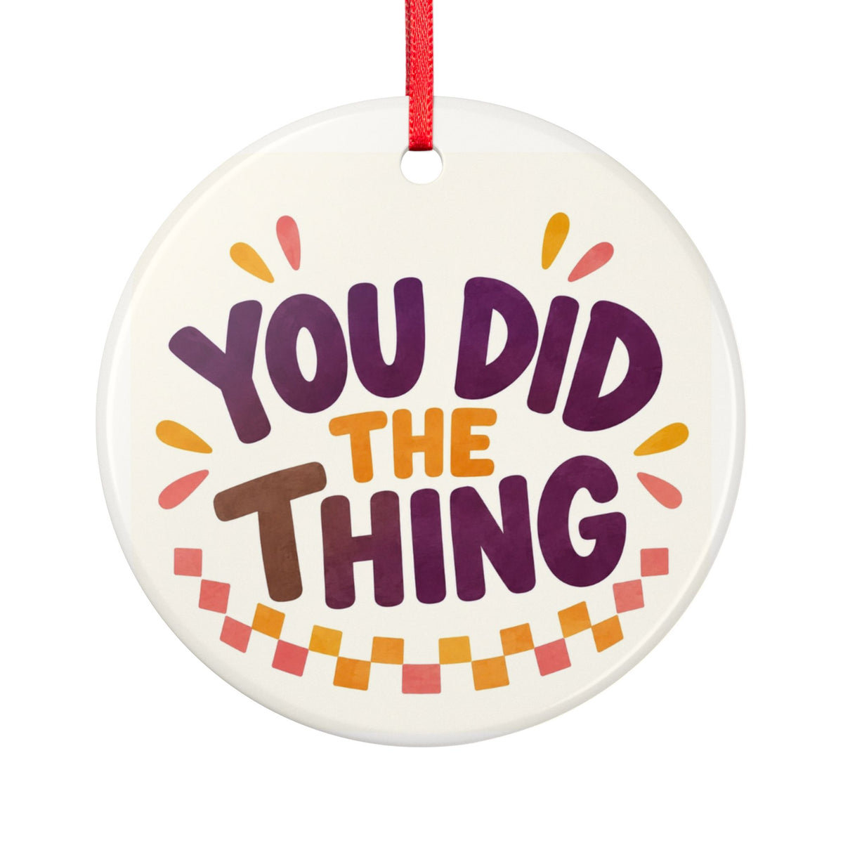 Round ceramic hanging ornament showing bold You Did the Thing lettering with confetti and a checker garland.