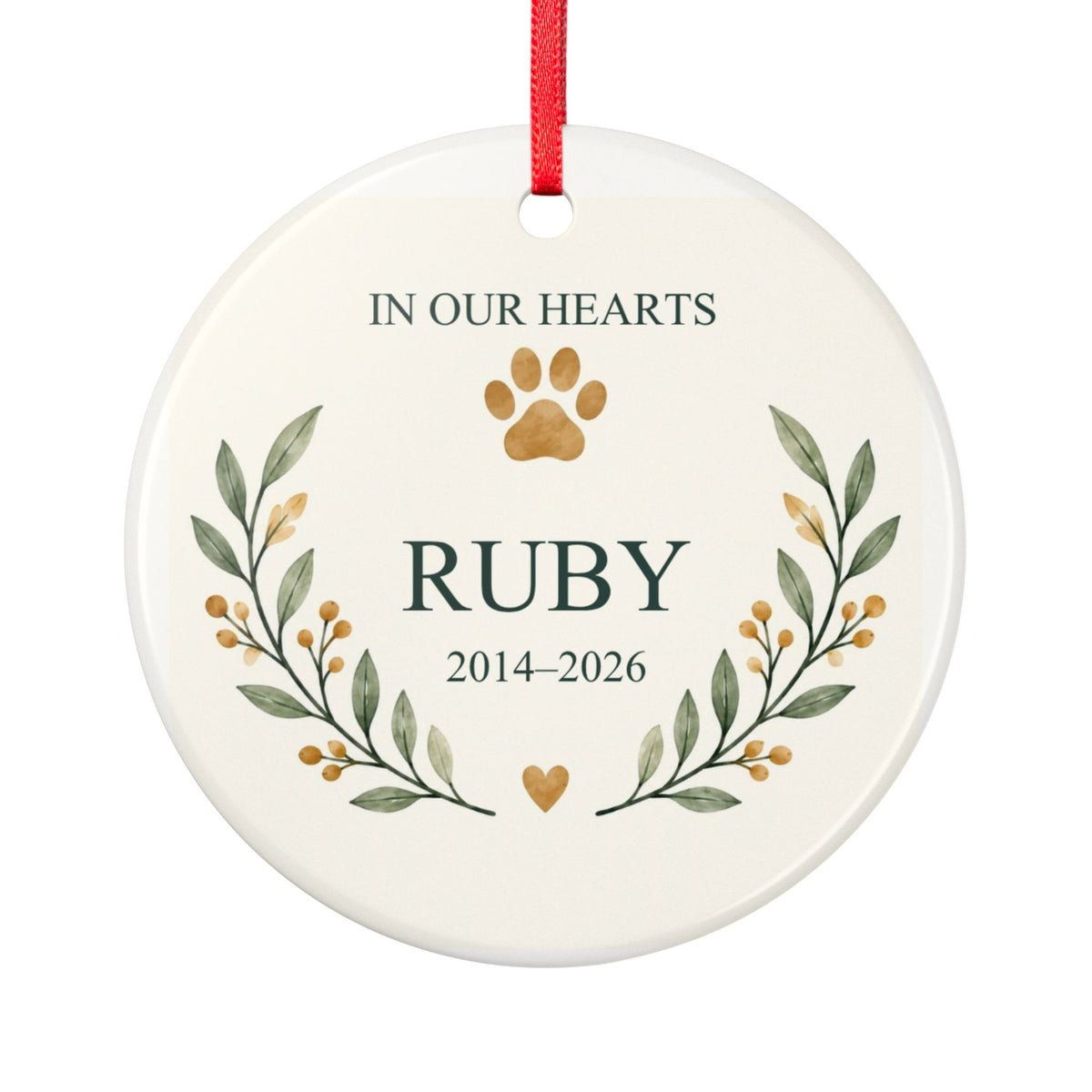 Round ceramic hanging ornament showing paw print and botanical branches around the sample name Ruby and sample years 2014–2026.