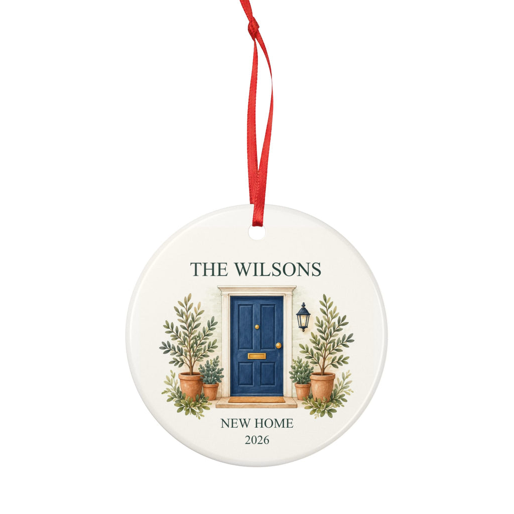 Round ceramic hanging ornament showing navy front door with plants, the sample family name The Wilsons and New Home wording.