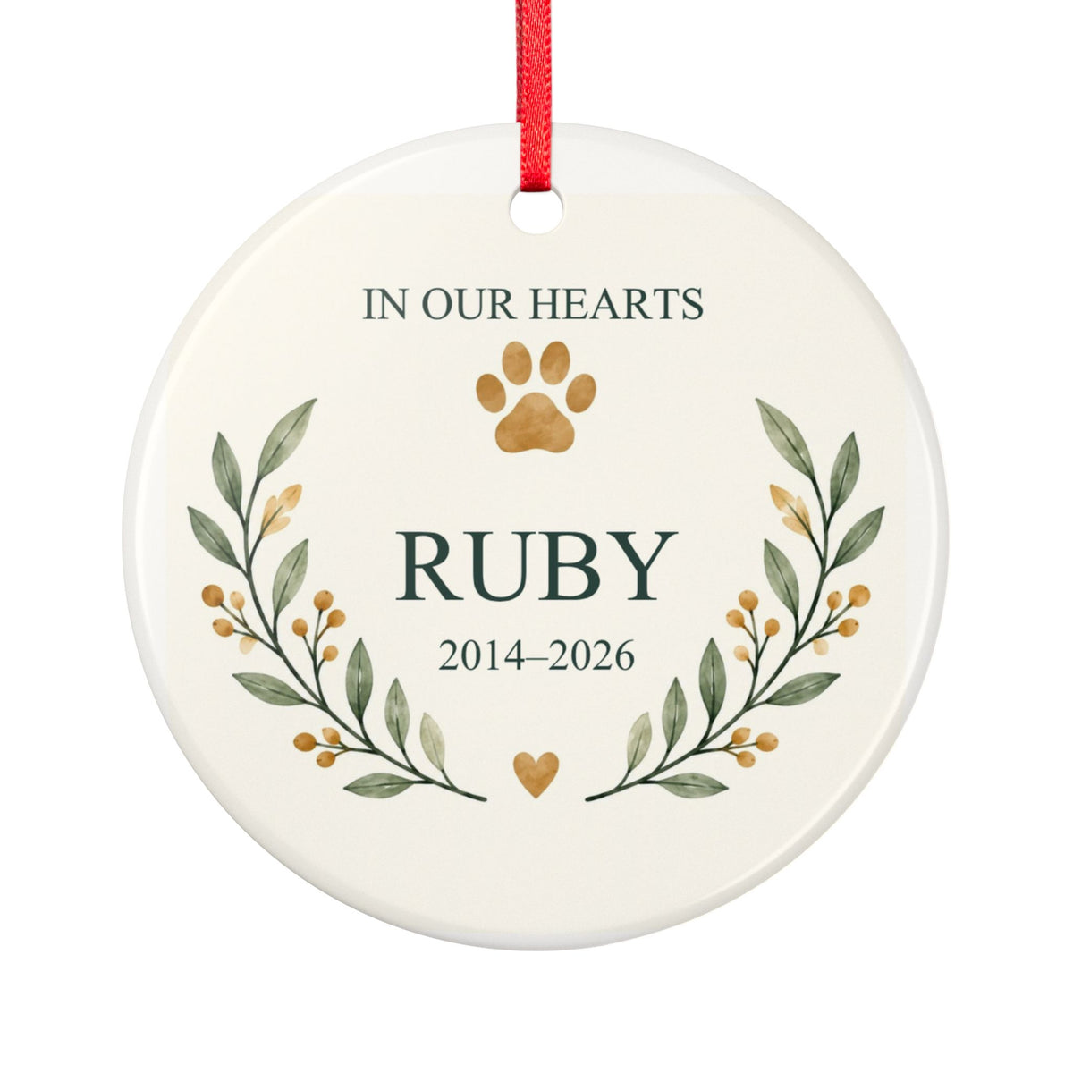 Round ceramic hanging ornament showing paw print and botanical branches around the sample name Ruby and sample years 2014–2026.