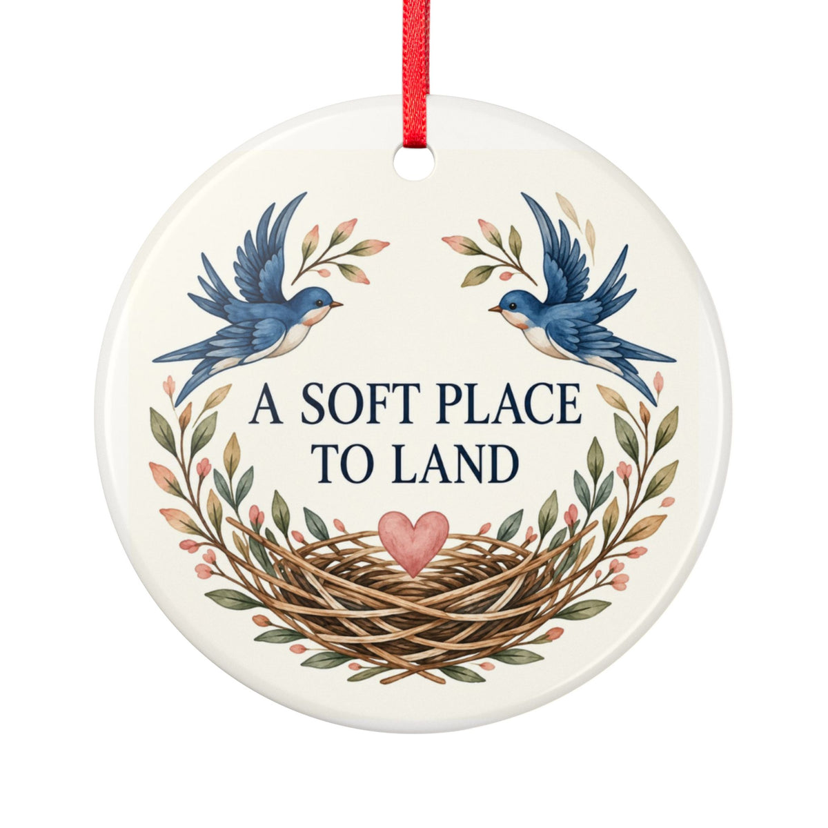 Round ceramic hanging ornament showing two blue birds, botanical sprigs, a nest and A Soft Place to Land lettering.