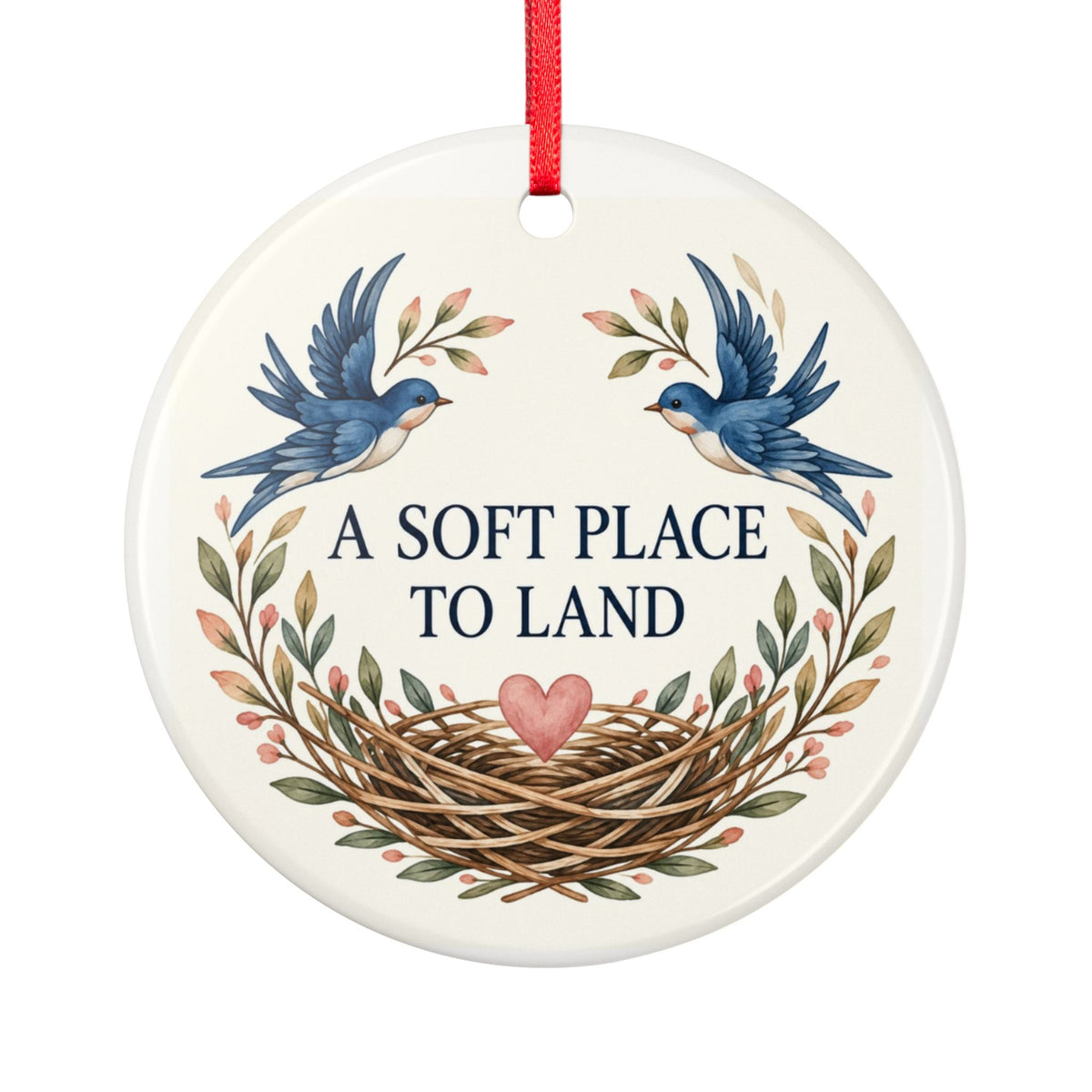 Round ceramic hanging ornament showing two blue birds, botanical sprigs, a nest and A Soft Place to Land lettering.