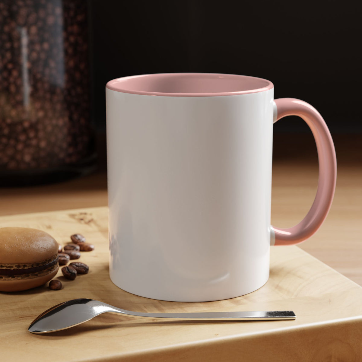 Rear view of the pink Built Different duck mug beside coffee beans