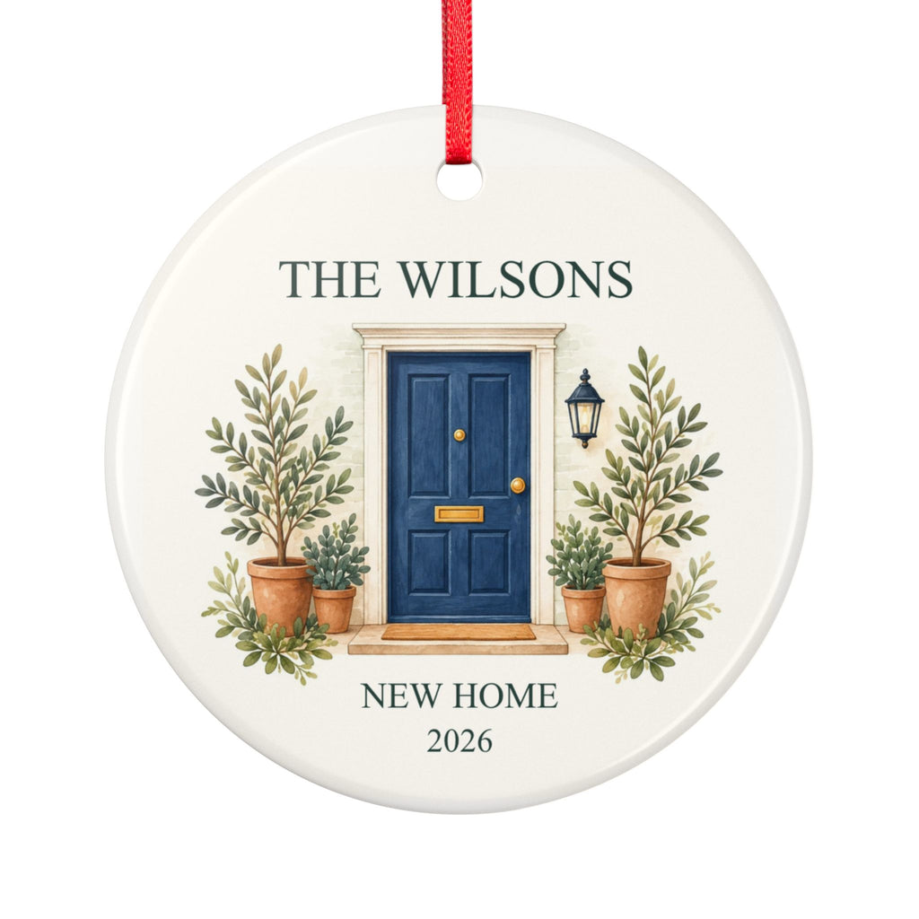 Round ceramic hanging ornament showing navy front door with plants, the sample family name The Wilsons and New Home wording.