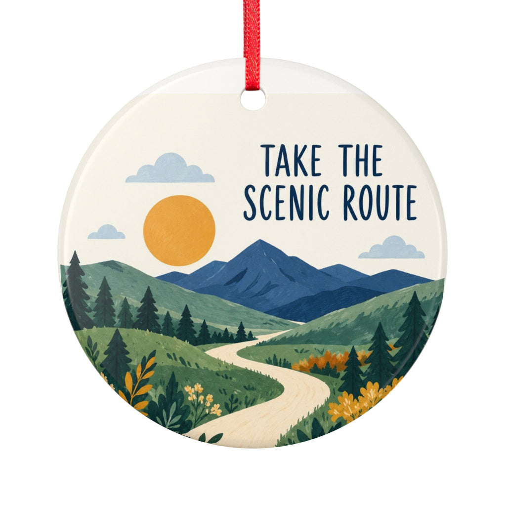 Round ceramic hanging ornament showing winding path through green hills and blue mountains with Take the Scenic Route lettering.