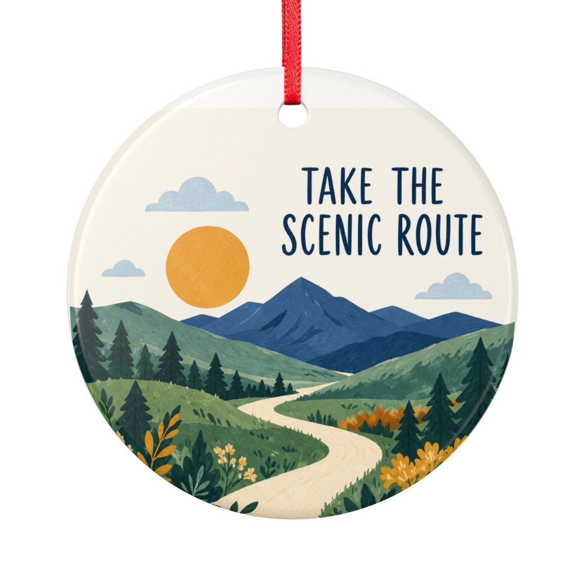 Round ceramic hanging ornament showing winding path through green hills and blue mountains with Take the Scenic Route lettering.