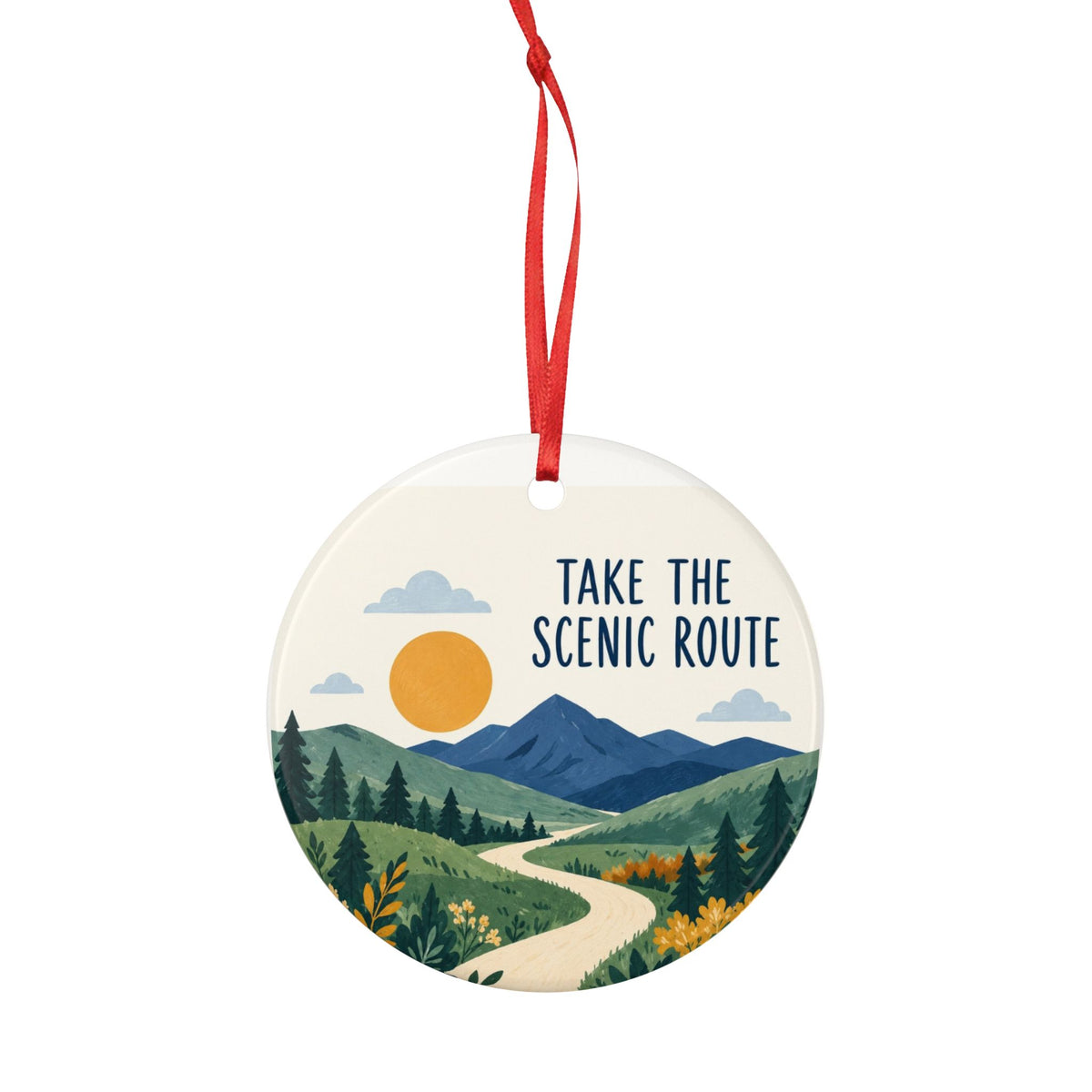 Round ceramic hanging ornament showing winding path through green hills and blue mountains with Take the Scenic Route lettering.