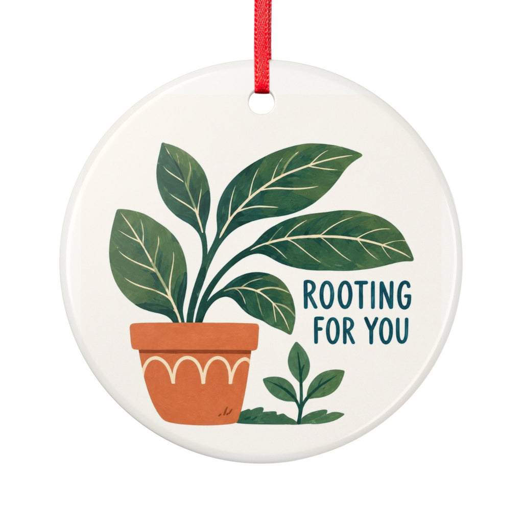 Round ceramic hanging ornament showing green leafy plant in a terracotta pot and Rooting for You lettering.
