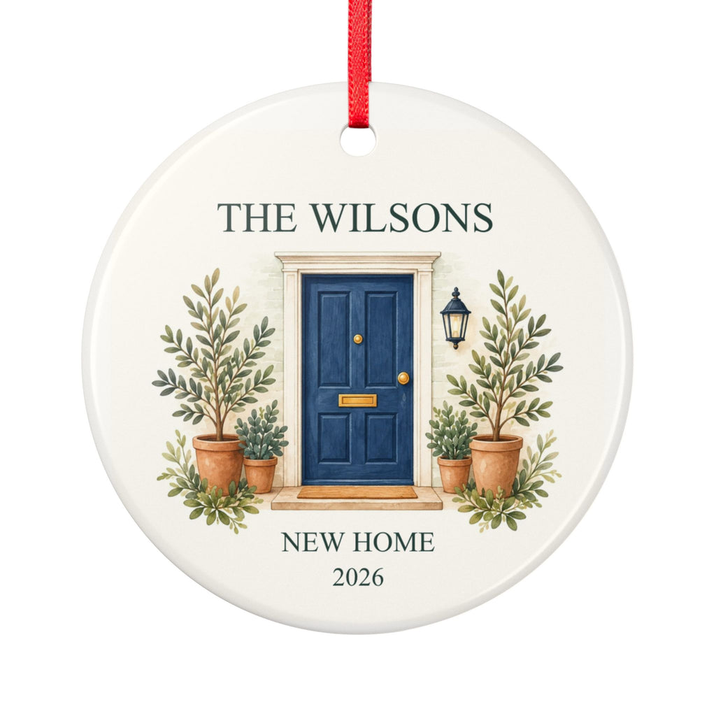 Round ceramic hanging ornament showing navy front door with plants, the sample family name The Wilsons and New Home wording.