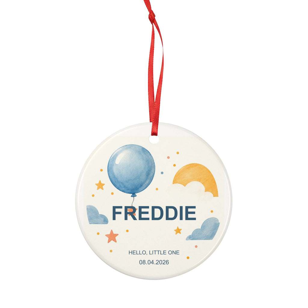 Round ceramic hanging ornament showing blue balloon, yellow sun and stars with the sample name Freddie and sample birth date.
