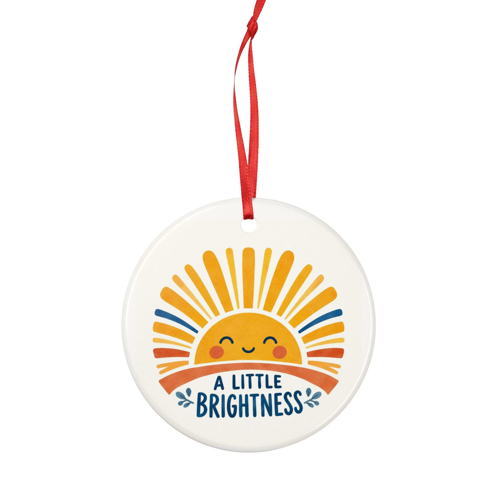Round ceramic hanging ornament showing smiling golden sun and blue A Little Brightness lettering.