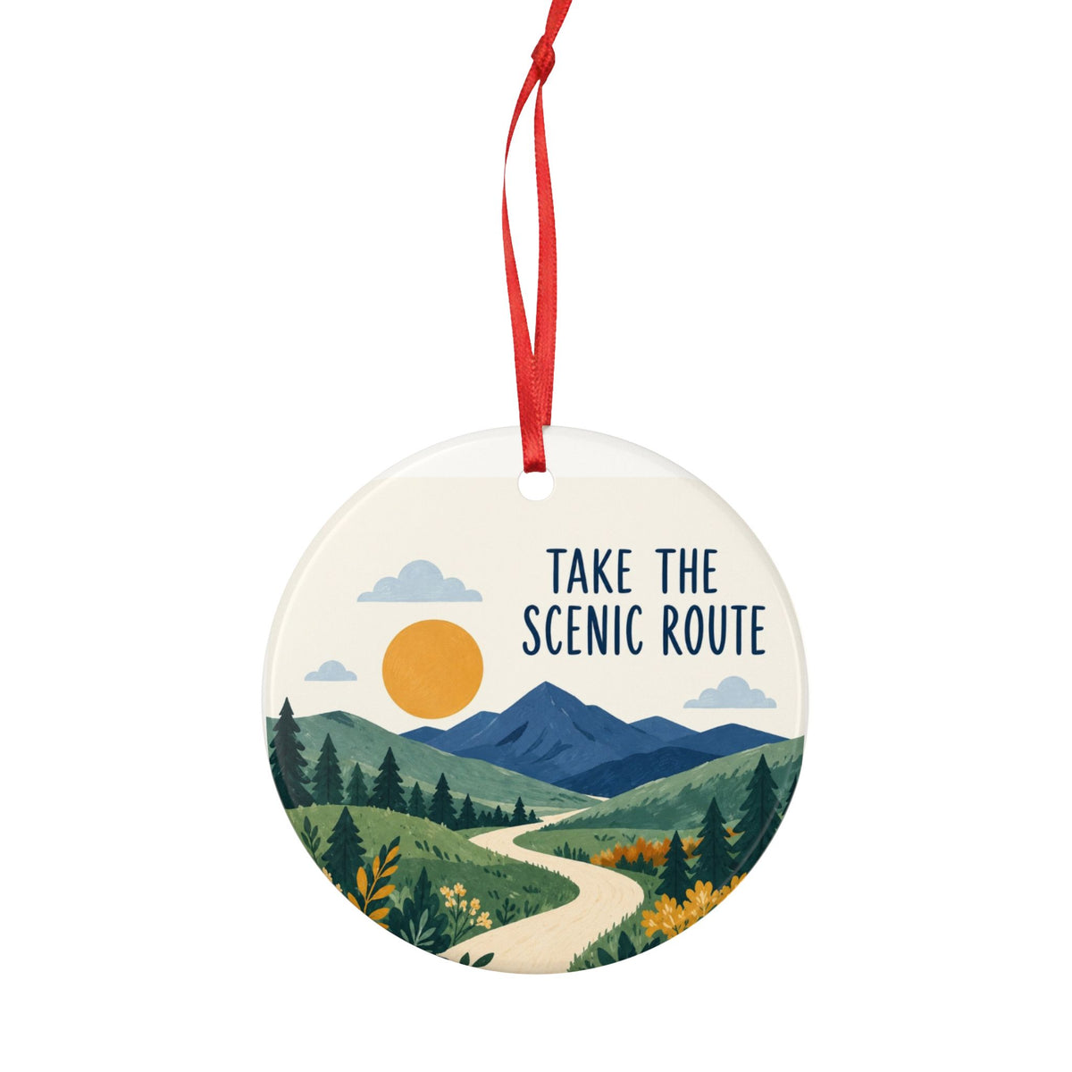 Round ceramic hanging ornament showing winding path through green hills and blue mountains with Take the Scenic Route lettering.