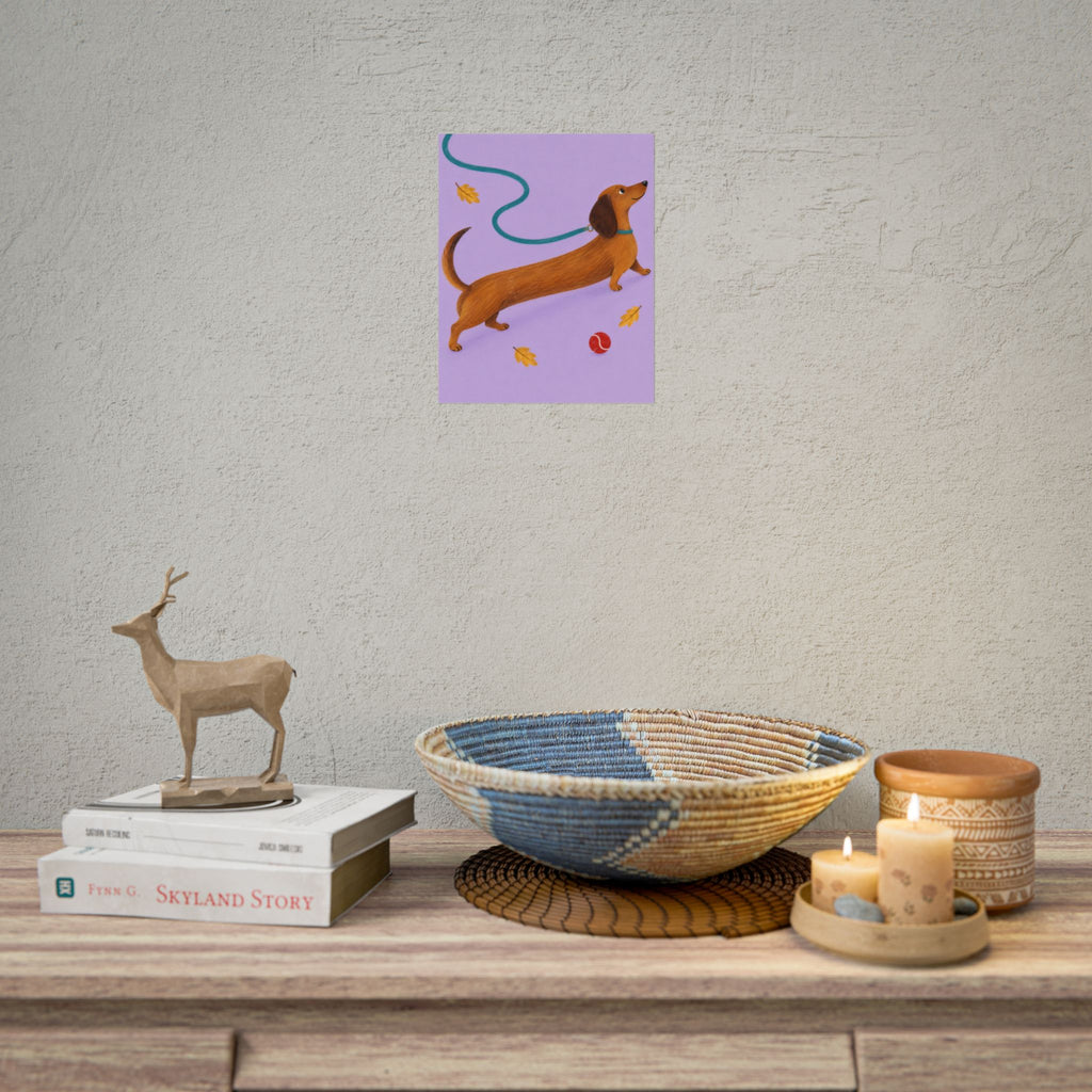 Long Dog, Big Day art print by Cozy Prints UK: caramel dachshund on lilac with a teal lead, yellow leaves and a red ball.