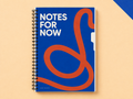 Notes for Now A5 wirebound notebook with a blue and orange abstract cover on a warm apricot backdrop.