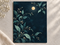 Night Garden unframed print with moonlit botanical branches on a softly lit stone surface.