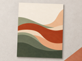 Soft Landing unframed abstract print with sage and terracotta curves on a warm grey surface.