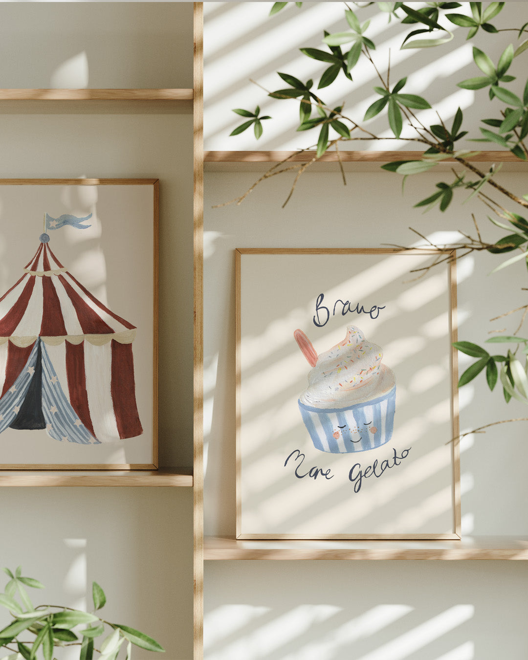 Bravo More Gelato print displayed on a wooden picture ledge beside circus artwork and leafy branches.
