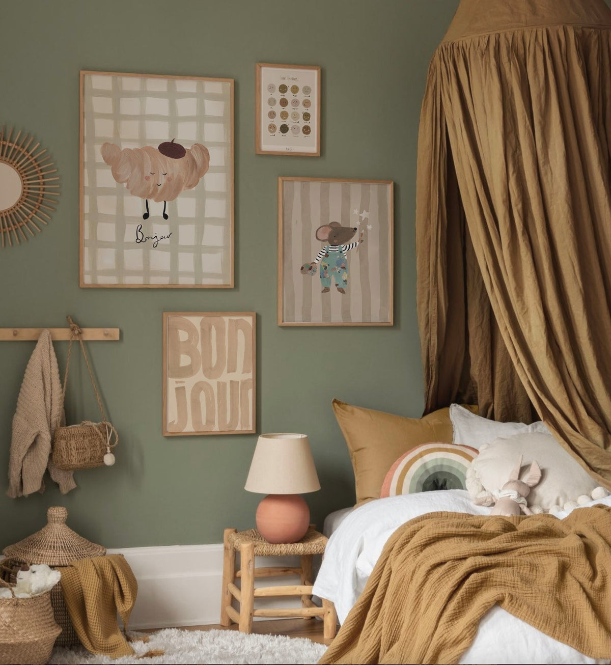 Croissant Bonjour print on a sage bedroom gallery wall beside a mustard bed canopy.