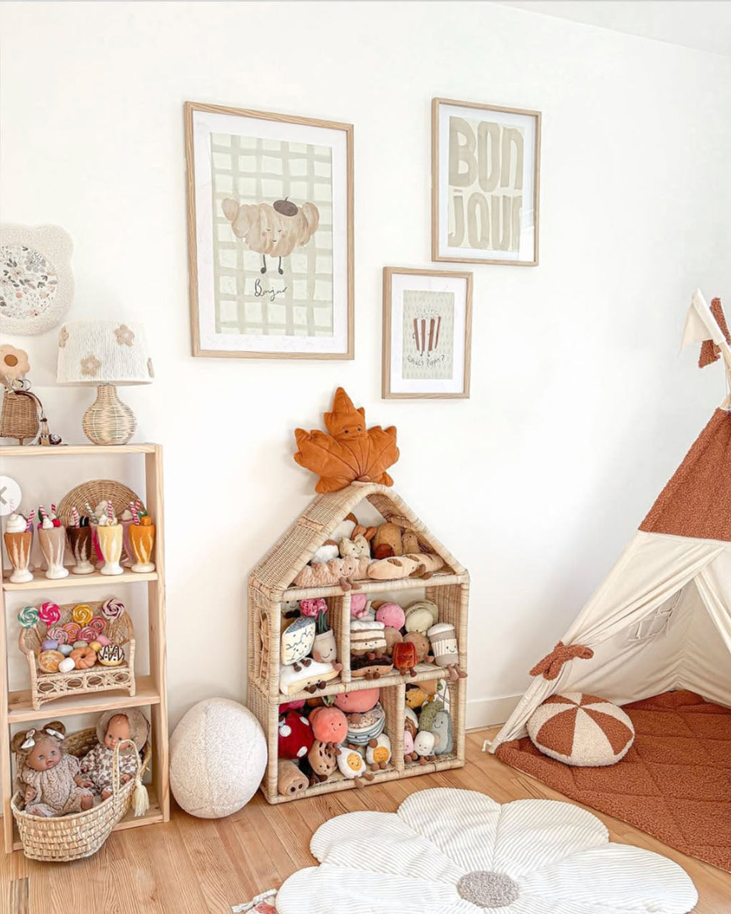 Croissant print displayed in a playroom gallery wall above toy shelves and beside a fabric teepee.